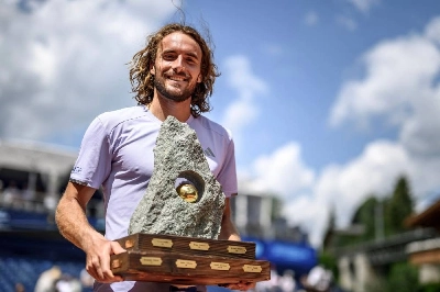 Greece's Stefanos Tsitsipas poses with the trophy following his victory against Belgium's Raphael Collignon in the Swiss Open final in Gstaad, on July 19, 2026. (AFP) Greece's Stefanos Tsitsipas poses with the trophy following his victory against Belgium's Raphael Collignon in the Swiss Open final in Gstaad, on July 19, 2026. (AFP)