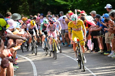 UAE Team Emirates - XRG's Slovenian rider Tadej Pogacar wearing the overall leader's yellow jersey attacks to take the lead in a lone breakaway ahead of Team Visma | Lease a Bike team's Danish rider Jonas Vingegaard, wearing the climber's dotted "King of the Mountains" jersey, in the final kilometers of the 14th stage of the Tour de France on July 18, 2026. (AFP) UAE Team Emirates - XRG's Slovenian rider Tadej Pogacar wearing the overall leader's yellow jersey attacks to take the lead in a lone breakaway ahead of Team Visma | Lease a Bike team's Danish rider Jonas Vingegaard, wearing the climber's dotted "King of the Mountains" jersey, in the final kilometers of the 14th stage of the Tour de France on July 18, 2026. (AFP)
