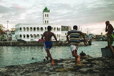 Children jump in the ocean in the former dhow port of Kalaweni, opposite the Grand Mosque, in Moroni's historic medina. AFP Children jump in the ocean in the former dhow port of Kalaweni, opposite the Grand Mosque, in Moroni's historic medina. AFP