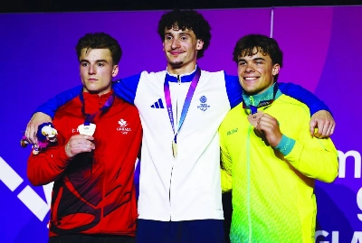 Gold medallist Scotland's Reuben Ward celebrates on the podium after winning the Men's All-Around Final along with silver medallist Canada's Felix Dolci and bronze medallist Australia's Jesse Moore at the Commonwealth Games 2026 in Glasgow on Sunday. (Reuters) Gold medallist Scotland's Reuben Ward celebrates on the podium after winning the Men's All-Around Final along with silver medallist Canada's Felix Dolci and bronze medallist Australia's Jesse Moore at the Commonwealth Games 2026 in Glasgow on Sunday. (Reuters)