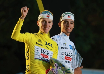 UAE Team Emirates XRG's Tadej Pogacar celebrates on the podium while wearing the yellow jersey after winning the Tour de France, alongside UAE Team Emirates XRG's Isaac Del Toro wearing the white jersey. (Reuters) UAE Team Emirates XRG's Tadej Pogacar celebrates on the podium while wearing the yellow jersey after winning the Tour de France, alongside UAE Team Emirates XRG's Isaac Del Toro wearing the white jersey. (Reuters)