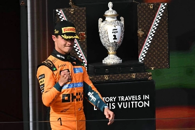Winner McLaren's British driver Lando Norris celebrates as he walks by the trophy during the podium ceremony after the Formula One Hungarian Grand Prix in Budapest on July 26, 2026. (AFP) Winner McLaren's British driver Lando Norris celebrates as he walks by the trophy during the podium ceremony after the Formula One Hungarian Grand Prix in Budapest on July 26, 2026. (AFP)