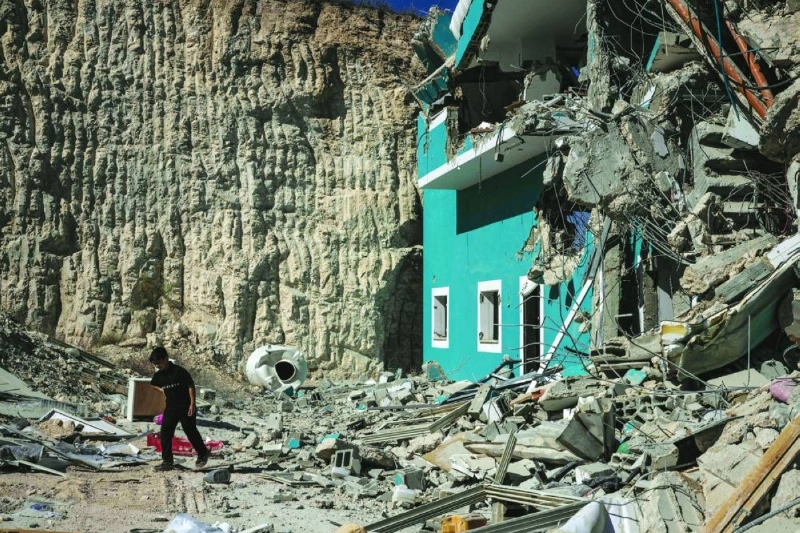 A young Palestinian boy walks in front a building containing shops and flats that were demolished by Israeli forces, citing the lack of a building permit, in Anzah, south of the Palestinian city of Jenin in the northern Israeli-occupied West Bank, on July 27, 2026. (AFP) A young Palestinian boy walks in front a building containing shops and flats that were demolished by Israeli forces, citing the lack of a building permit, in Anzah, south of the Palestinian city of Jenin in the northern Israeli-occupied West Bank, on July 27, 2026. (AFP)
