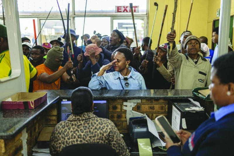This picture taken on Thursday shows a woman reacting as protesters storm the Department of Home Affairs offices during a demonstration calling for the removal of undocumented immigrants in South Africa’s Alexandra township. – AFP This picture taken on Thursday shows a woman reacting as protesters storm the Department of Home Affairs offices during a demonstration calling for the removal of undocumented immigrants in South Africa’s Alexandra township. – AFP