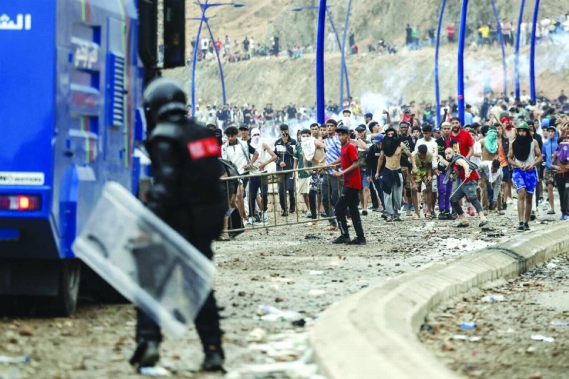 Moroccan security forces clash with migrants attempting to cross into Spain's North African enclave of Ceuta near the town of Fnideq, on the Morocco-Spain border, on July 31, 2026. The European Union on July 31 scrambled to contain one of the largest migrant crises faced by the block in recent years, after tens of thousands of people poured into into Spain's North African Ceuta enclave in just days. (Photo by Abdel Majid BZIOUAT / AFP) Moroccan security forces clash with migrants attempting to cross into Spain's North African enclave of Ceuta near the town of Fnideq, on the Morocco-Spain border, on July 31, 2026. The European Union on July 31 scrambled to contain one of the largest migrant crises faced by the block in recent years, after tens of thousands of people poured into into Spain's North African Ceuta enclave in just days. (Photo by Abdel Majid BZIOUAT / AFP)