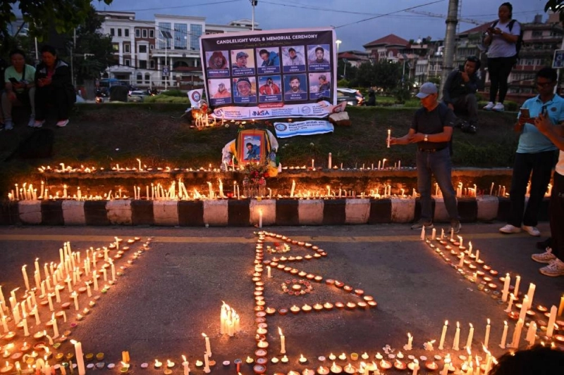 Mourners light candles before the portraits of mountaineer Nirmal Purja and his companions, who were killed in an avalanche in Pakistan, during a memorial ceremony in Kathmandu yesterday. (AFP) Mourners light candles before the portraits of mountaineer Nirmal Purja and his companions, who were killed in an avalanche in Pakistan, during a memorial ceremony in Kathmandu yesterday. (AFP)