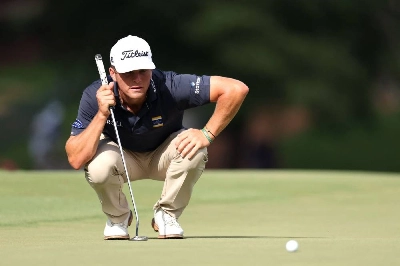 Michael Brennan of the United States lines up a putt on the 18th green during the third round of the Wyndham Championship at Sedgefield Country Club in Greensboro, North Carolina. (AFP) Michael Brennan of the United States lines up a putt on the 18th green during the third round of the Wyndham Championship at Sedgefield Country Club in Greensboro, North Carolina. (AFP)