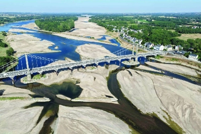 This aerial photograph shows a bridge over the dried out Loire River bed in Loireauxence (Varades), western France, on July 10, 2026. Climate change has intensified a drought across Europe this summer, with extreme heat driving the exceptionally dry conditions, according to experts. (AFP) This aerial photograph shows a bridge over the dried out Loire River bed in Loireauxence (Varades), western France, on July 10, 2026. Climate change has intensified a drought across Europe this summer, with extreme heat driving the exceptionally dry conditions, according to experts. (AFP)