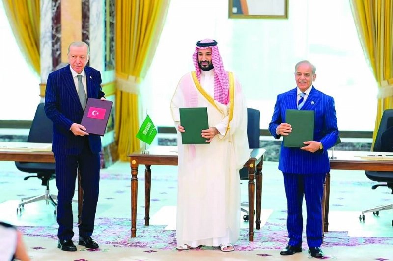 Saudi Crown Prince Mohammed bin Salman, Turkish President Recep Tayyip Erdogan (left) and Pakistani Prime Minister Shehbaz Sharif pose for a group photo after signing the Makkah Joint Defence Agreement last week. (AFP)
Saudi Crown Prince Mohammed bin Salman, Turkish President Recep Tayyip Erdogan (left) and Pakistani Prime Minister Shehbaz Sharif pose for a group photo after signing the Makkah Joint Defence Agreement last week. (AFP)