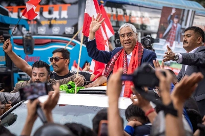Former Nepal's prime minister Sher Bahadur Deuba waves to supporters outside the airport upon his arrival in Kathmandu yesterday. (AFP) Former Nepal's prime minister Sher Bahadur Deuba waves to supporters outside the airport upon his arrival in Kathmandu yesterday. (AFP)