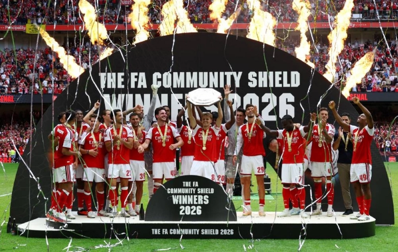 Arsenal's captain Martin Odegaard lifts the trophy as he celebrates with team-mates after winning the FA Community Shield at the Principality Stadium in Cardiff. (Reuters)