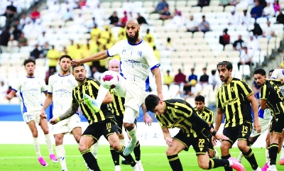 Al Wakrah and Qatar SC players tussle for the ball during the Qatar Stars League match at the Lusail stadium. Al Wakrah and Qatar SC players tussle for the ball during the Qatar Stars League match at the Lusail stadium.