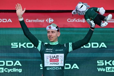 Slovenian rider Tadej Pogacar celebrates on the podium wearing the points ranking leader's jersey after winning the first stage of the Vuelta a Espana 2026, a 9,4 km time-trial between Monaco and Monaco on August 22, 2026. (AFP) Slovenian rider Tadej Pogacar celebrates on the podium wearing the points ranking leader's jersey after winning the first stage of the Vuelta a Espana 2026, a 9,4 km time-trial between Monaco and Monaco on August 22, 2026. (AFP)