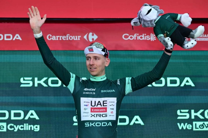 Slovenian rider Tadej Pogacar celebrates on the podium wearing the points ranking leader's jersey after winning the first stage of the Vuelta a Espana 2026, a 9,4 km time-trial between Monaco and Monaco on August 22, 2026. (AFP) Slovenian rider Tadej Pogacar celebrates on the podium wearing the points ranking leader's jersey after winning the first stage of the Vuelta a Espana 2026, a 9,4 km time-trial between Monaco and Monaco on August 22, 2026. (AFP)