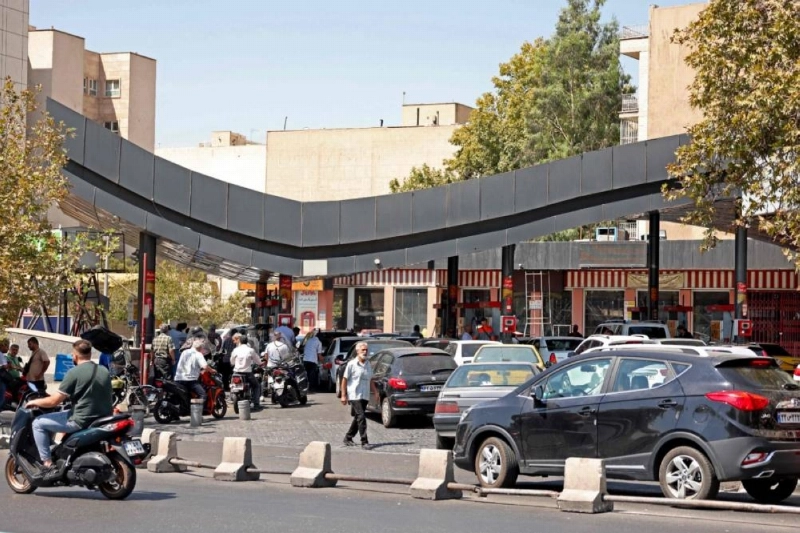 Drivers queue at a petrol station to refuel in Tehran on Tuesday. Six months ago, US and Israeli attacks on Iran triggered what has become the largest oil supply crisis on record, with no clear end in sight. Drivers queue at a petrol station to refuel in Tehran on Tuesday. Six months ago, US and Israeli attacks on Iran triggered what has become the largest oil supply crisis on record, with no clear end in sight.
