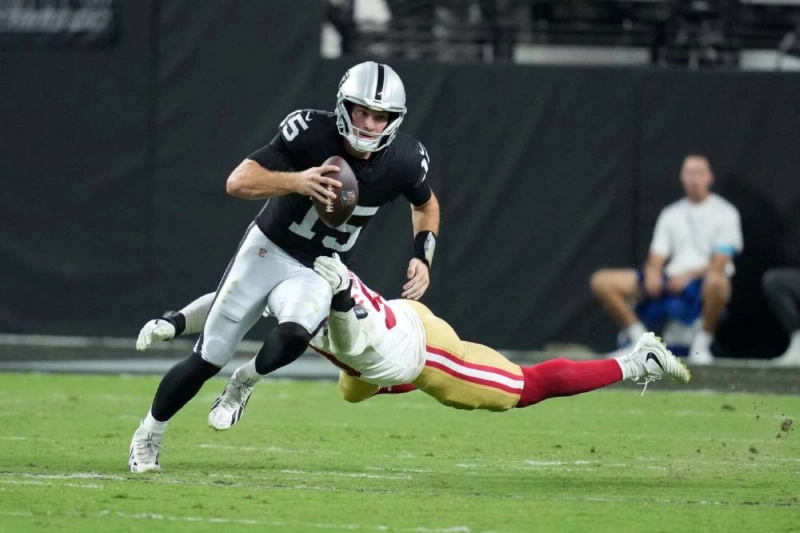 Las Vegas Raiders quarterback Fernando Mendoza (15) carries the ball against San Francisco 49ers linebacker Jaden Dugger (53) at Allegiant Stadium in Paradise, Nevada, USA. (Reuters) Las Vegas Raiders quarterback Fernando Mendoza (15) carries the ball against San Francisco 49ers linebacker Jaden Dugger (53) at Allegiant Stadium in Paradise, Nevada, USA. (Reuters)