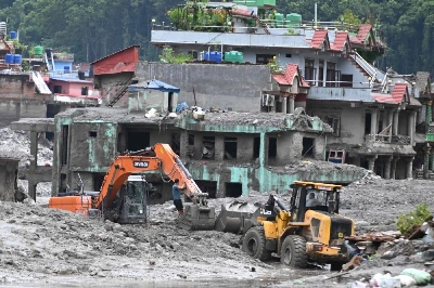 An excavator helps people to collect some of their belongings from their house in the aftermath of flash floods at Trishuli, in Nepal's Nuwakot district, yesterday. (AFP) An excavator helps people to collect some of their belongings from their house in the aftermath of flash floods at Trishuli, in Nepal's Nuwakot district, yesterday. (AFP)