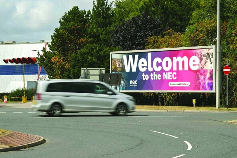 A car passes by a welcome sign for the National Exhibition Centre (NEC) as the Reform UK party hosts the first day of their annual party conference inside the arena in Birmingham, central England yesterday. (AFP) A car passes by a welcome sign for the National Exhibition Centre (NEC) as the Reform UK party hosts the first day of their annual party conference inside the arena in Birmingham, central England yesterday. (AFP)