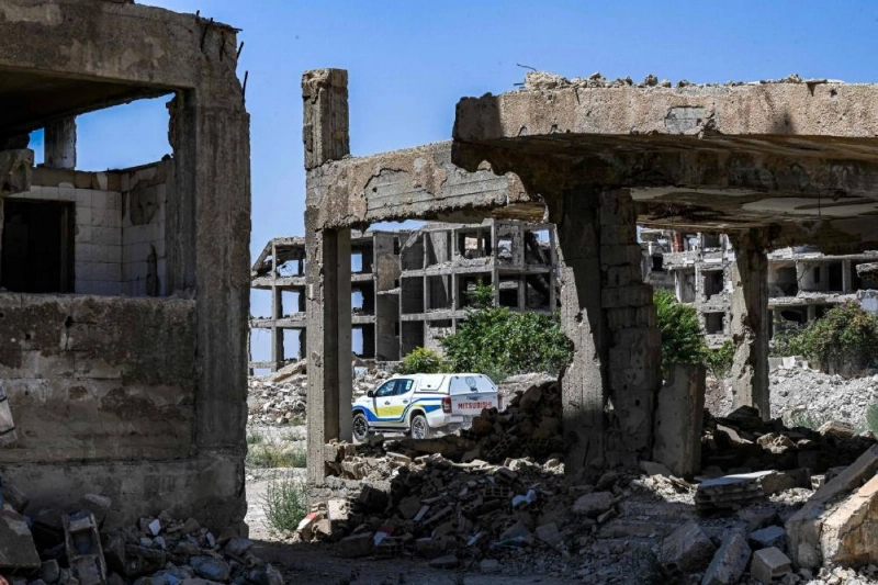 Heavily-damaged and destroyed buildings are pictured in the Jobar suburb northeast of Damascus on August 12, 2026. Since the December 2024 overthrow of longtime Syrian ruler Bashar al-Assad, international organisations and NGOs led by the United Nations Mine Action Service (UNMAS) say incidents involving unexploded ordnance have killed or injured at least 2,375 people, including more than 850 children. The real toll is thought to be much higher. During more than 13 years of war, different sides planted mines and explosive devices in various parts of the country, presenting a dangerous challenge as Syria seeks to recover and rebuild. (Photo by LOUAI BESHARA / AFP) Heavily-damaged and destroyed buildings are pictured in the Jobar suburb northeast of Damascus on August 12, 2026. Since the December 2024 overthrow of longtime Syrian ruler Bashar al-Assad, international organisations and NGOs led by the United Nations Mine Action Service (UNMAS) say incidents involving unexploded ordnance have killed or injured at least 2,375 people, including more than 850 children. The real toll is thought to be much higher. During more than 13 years of war, different sides planted mines and explosive devices in various parts of the country, presenting a dangerous challenge as Syria seeks to recover and rebuild. (Photo by LOUAI BESHARA / AFP)