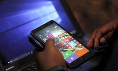 A Microsoft delegate checks applications on a smartphone during the launch of the Windows 10 operating system in Kenya's capital Nairobi, July 29, 2015. Microsoft Corp's launch of its first new operating system in almost three years, designed to work across laptops, desktop and smartphones, won mostly positive reviews for its user-friendly and feature-packed interface. REUTERS/Thomas Mukoya - RTX1MBCR