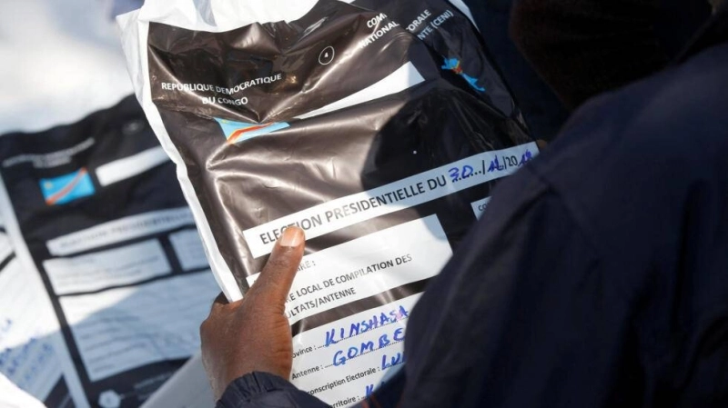 A man holds a bag containing voting materials at Congo's Independent National Electoral Commission (CENI) tallying centre in Kinshasa, Democratic Republic of Congo, January 1, 2019. REUTERS/Baz Ratner