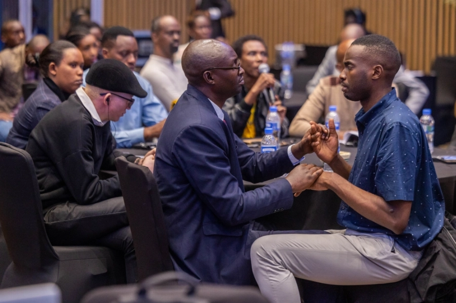A sign language interpreter helps a delegate with disabilities during the conference. A sign language interpreter helps a delegate with disabilities during the conference.