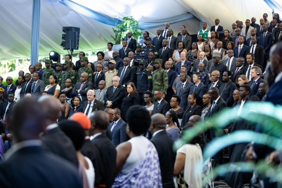 Mourners observe a moment a silence to pay tribute to the victims at the event. Mourners observe a moment a silence to pay tribute to the victims at the event.