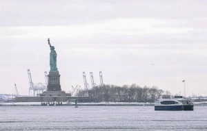 A ferry passes by the Statue of Liberty in New York, New York, USA on January 26, 2026. A blizzard swept across the country, bringing record snowfall and sub-zero temperatures. —EPA