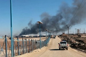 Smoke rises from al-Hol camp, home to a family believed to be Islamic State (IS) group fighters, after the Syrian government took control of the area in Syria's Hassakeh province on January 21, 2026. —EPA