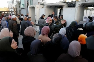Palestinians wait at a Bethlehem checkpoint to enter Jerusalem for First Friday Ramadan prayers at Al-Aqsa Mosque despite Israeli restrictions