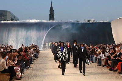 Louis Vuitton designer Pharrell Williams uses giant tidal wave set as backdrop for Paris fashion show