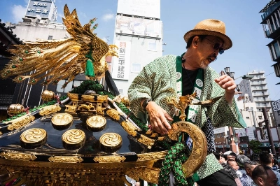 A man stands atop a float holding a portable shrine at this year’s Sanja Festival in Tokyo. A man stands atop a float holding a portable shrine at this year’s Sanja Festival in Tokyo.