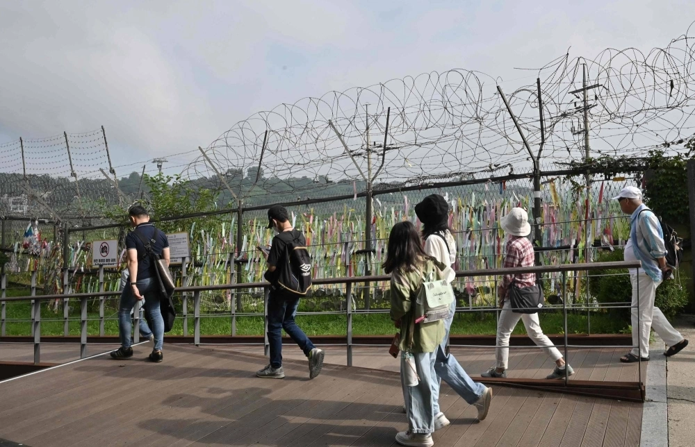 Visitors walk past a military fence at Imjingak peace park in the border city of Paju on Wednesday.  Visitors walk past a military fence at Imjingak peace park in the border city of Paju on Wednesday.