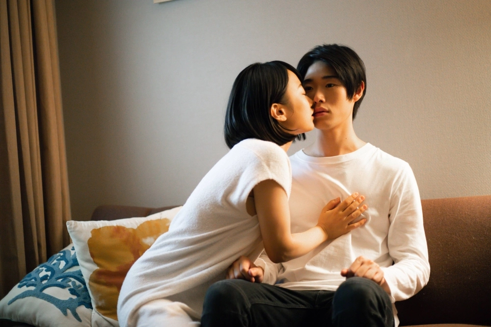 A lonely woman (Ayaka Nakagochi, left) develops romantic feelings for her personal care humanoid (Kosei Kudo) in “12 Months of Kai.” A lonely woman (Ayaka Nakagochi, left) develops romantic feelings for her personal care humanoid (Kosei Kudo) in “12 Months of Kai.”