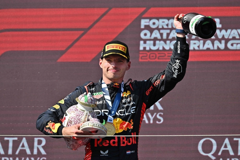 Max Verstappen leaves the podium with his broken trophy after the Formula One Hungarian Grand Prix in Mogyorod, Hungary, on Sunday. Max Verstappen leaves the podium with his broken trophy after the Formula One Hungarian Grand Prix in Mogyorod, Hungary, on Sunday.