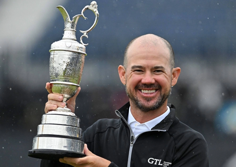Brian Harman poses with the Claret Jug after winning the British Open in Hoylake, England, on Sunday. Brian Harman poses with the Claret Jug after winning the British Open in Hoylake, England, on Sunday.