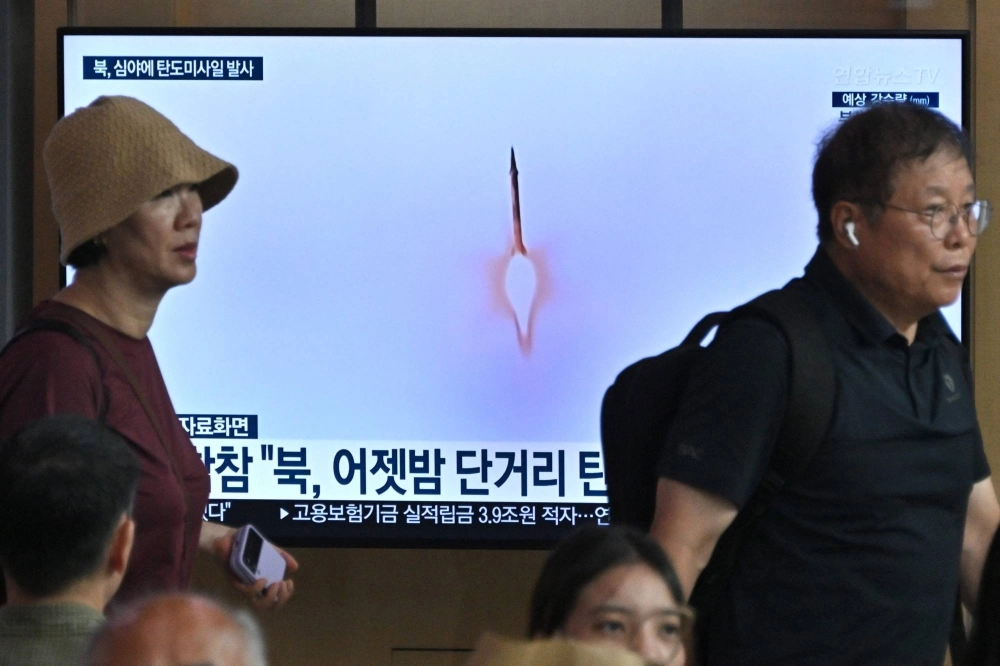 People walk past a television screen showing a news broadcast with file footage of a North Korean missile test at the main railway station in Seoul on Tuesday. People walk past a television screen showing a news broadcast with file footage of a North Korean missile test at the main railway station in Seoul on Tuesday.
