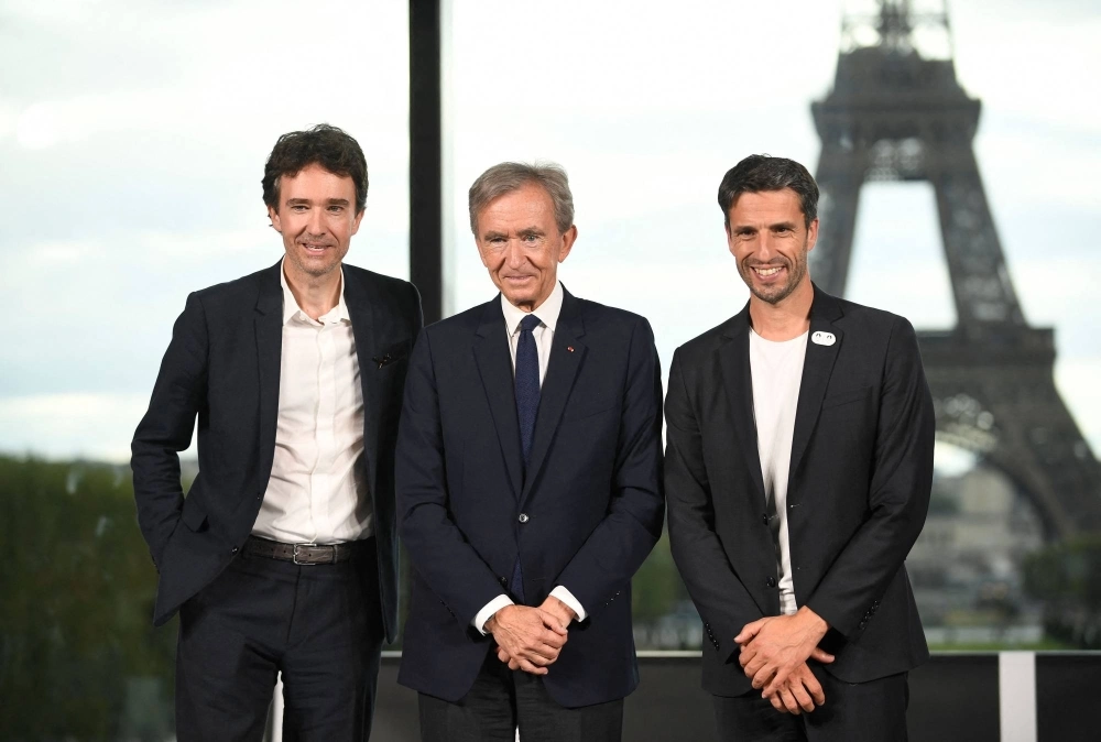 LVMH CEO Antoine Arnault (left), LVMH head Bernard Arnault (center) and Paris 2024 Organising Committee President Tony Estanguer pose at a news conference announcing the luxury titan as a premium sponsor of the Paris Games on Monday. LVMH CEO Antoine Arnault (left), LVMH head Bernard Arnault (center) and Paris 2024 Organising Committee President Tony Estanguer pose at a news conference announcing the luxury titan as a premium sponsor of the Paris Games on Monday.