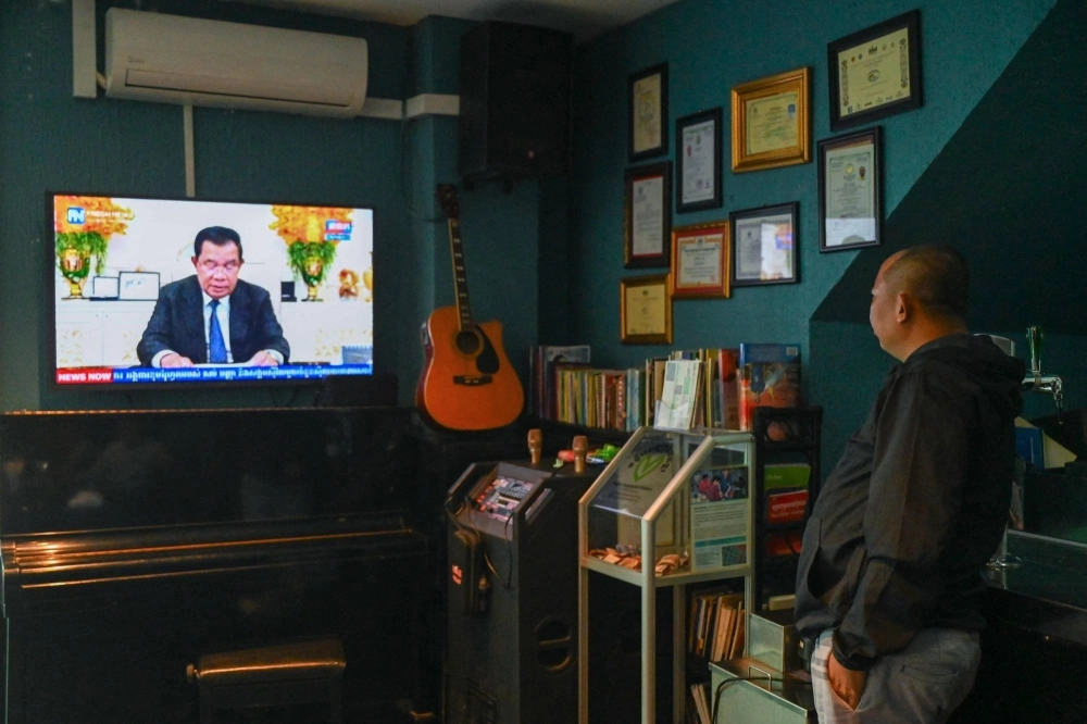 A man watches as Cambodia's Prime Minister Hun Sen speaks during a special statement on television at a restaurant in Phnom Penh on Wednesday. Hun Sen, one of the world's longest-serving leaders, said he will resign and hand power to his son, after almost four decades of hardline rule.  A man watches as Cambodia's Prime Minister Hun Sen speaks during a special statement on television at a restaurant in Phnom Penh on Wednesday. Hun Sen, one of the world's longest-serving leaders, said he will resign and hand power to his son, after almost four decades of hardline rule.
