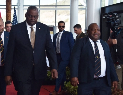 U.S. Defense Secretary Lloyd Austin (left) and Papua New Guinea Defense Minister Win Bakri Daki walk to their meeting in Port Moresby on Thursday. U.S. Defense Secretary Lloyd Austin (left) and Papua New Guinea Defense Minister Win Bakri Daki walk to their meeting in Port Moresby on Thursday.