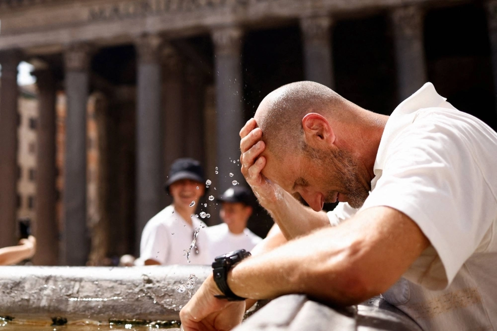 A man cools off at a fountain near the Pantheon during a heat wave in Rome on July 19. A man cools off at a fountain near the Pantheon during a heat wave in Rome on July 19.