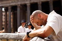 A man cools off at a fountain near the Pantheon during a heat wave in Rome on July 19. | REUTERS