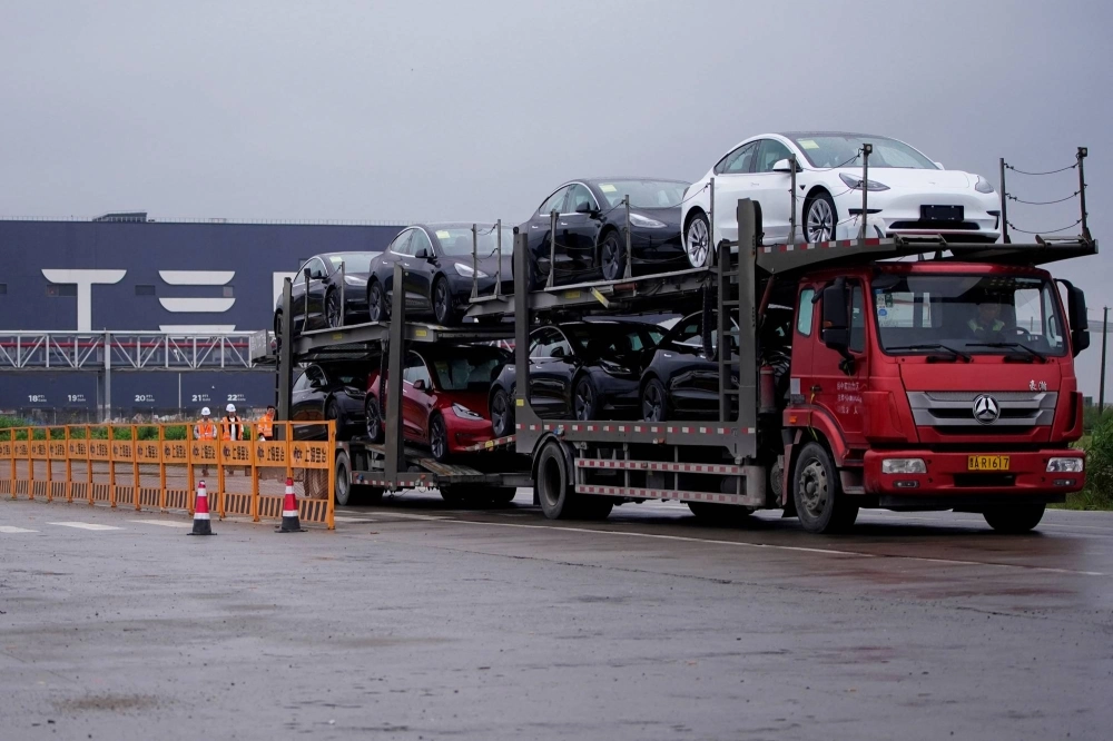 A truck transports new Tesla cars at its factory in Shanghai in May 2021. A truck transports new Tesla cars at its factory in Shanghai in May 2021.