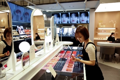 A woman shops for cosmetics at a department store in Seoul in July 2020. A woman shops for cosmetics at a department store in Seoul in July 2020.