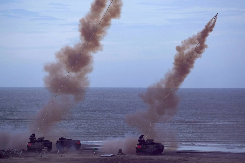 Taiwanese soldiers fire an ML154 Mine Clearance Launcher during the annual Han Guang anti-landing drill at Bali beach, New Taipei City, on Thursday. Taiwanese soldiers fire an ML154 Mine Clearance Launcher during the annual Han Guang anti-landing drill at Bali beach, New Taipei City, on Thursday.
