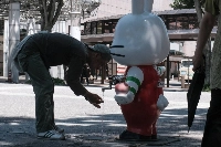 A man at a water faucet near Fukushima Station in the city of Fukushima, on July 6. | Bloomberg