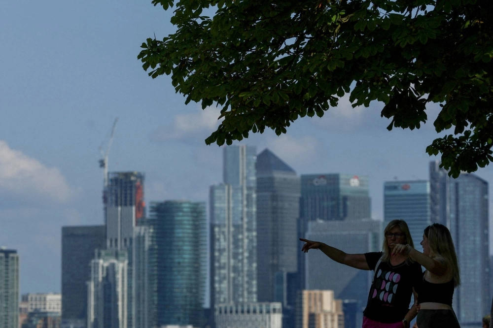 The towers of Canary Wharf, in London, occupied by several major international banks, seen from Greenwich Park in the city The towers of Canary Wharf, in London, occupied by several major international banks, seen from Greenwich Park in the city