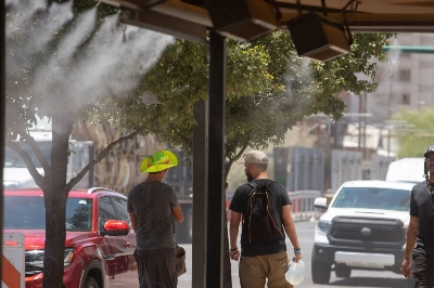 Residents walk through misters during a heat wave in Phoenix, Arizona, on July 20. Residents walk through misters during a heat wave in Phoenix, Arizona, on July 20.