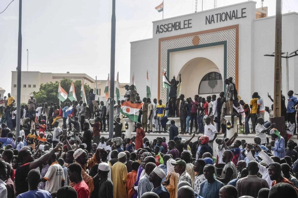 Supporters wave flags as they rally in support of Niger's junta in front of the National Assembly in Niamey on Sunday. Supporters wave flags as they rally in support of Niger's junta in front of the National Assembly in Niamey on Sunday.