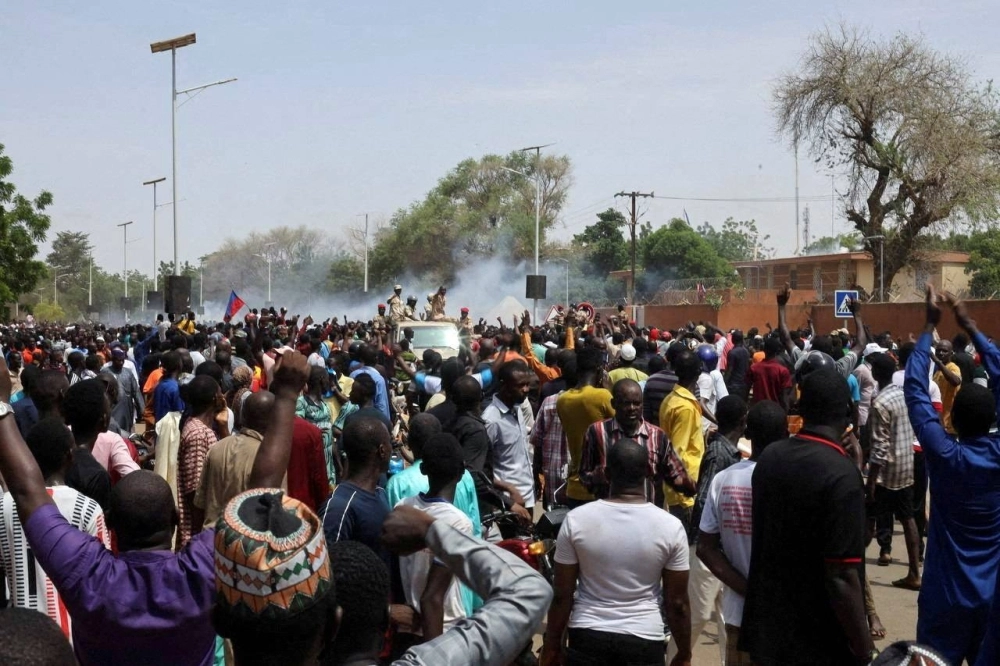 Nigerien security forces launch tear gas to disperse pro-junta demonstrators gathered outside the French embassy, in Niamey, the capital city of Niger, on Sunday. Nigerien security forces launch tear gas to disperse pro-junta demonstrators gathered outside the French embassy, in Niamey, the capital city of Niger, on Sunday.